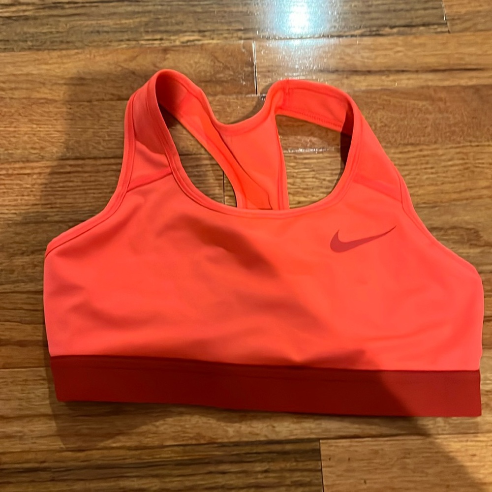 Orange bra no pads with a Nike logo on front with crossover back